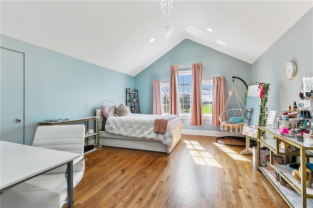 bedroom featuring hardwood / wood-style floors and lofted ceiling