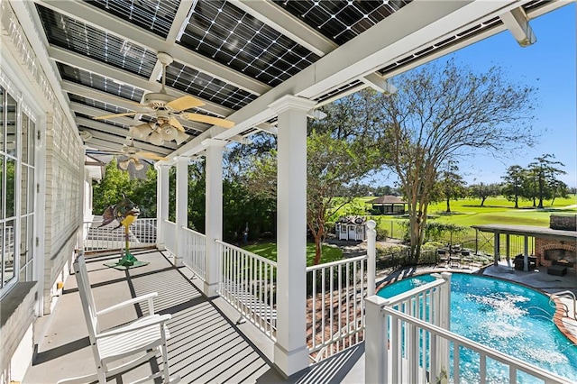 view of swimming pool featuring ceiling fan