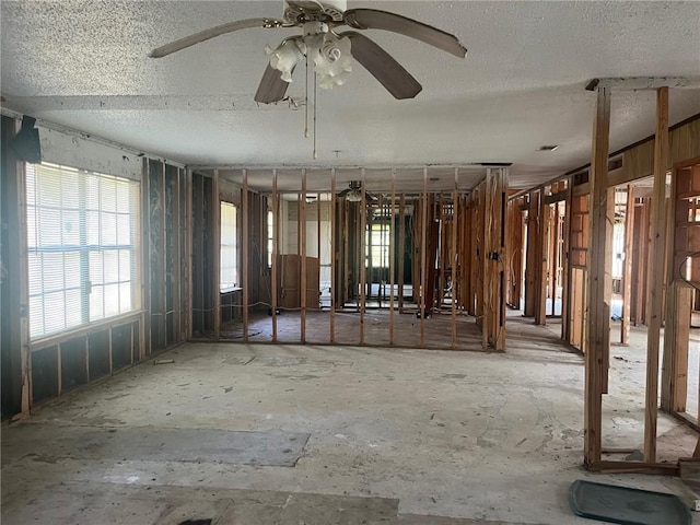 misc room with ceiling fan and a textured ceiling