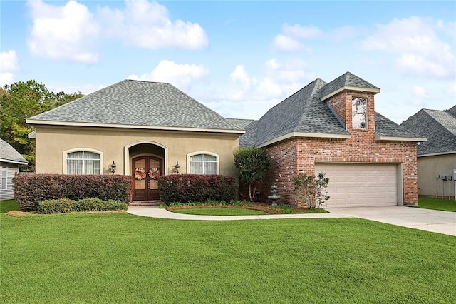 view of front of property with french doors, a garage, and a front lawn