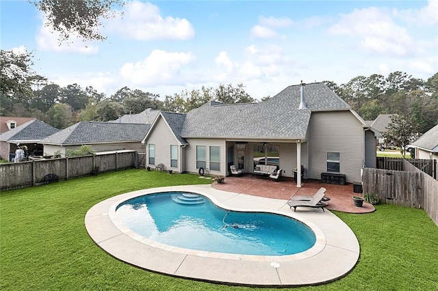 rear view of property featuring outdoor lounge area, a yard, a patio, and ceiling fan