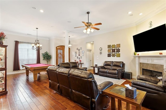 living room featuring dark hardwood / wood-style floors, ornamental molding, ceiling fan with notable chandelier, and billiards