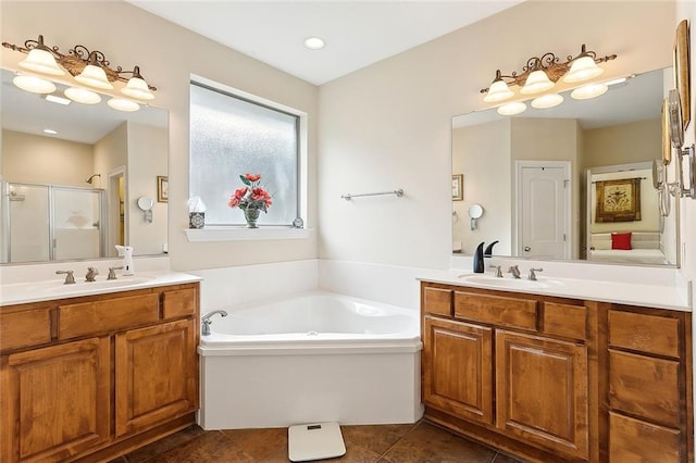 bathroom with shower with separate bathtub, vanity, and tile patterned floors