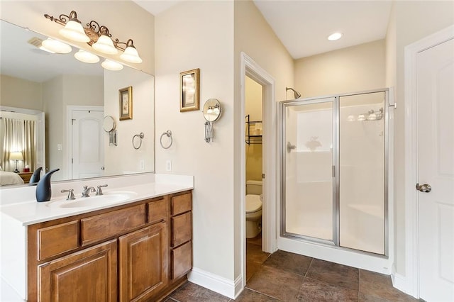 bathroom featuring vanity, toilet, and walk in shower