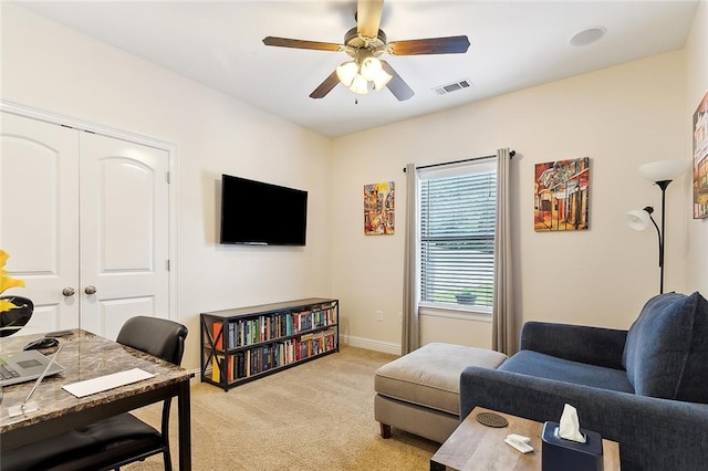 living room featuring light carpet and ceiling fan