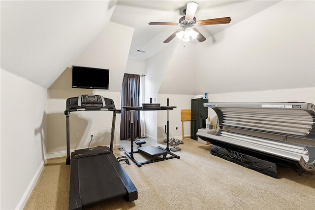 workout room featuring carpet flooring, ceiling fan, and vaulted ceiling