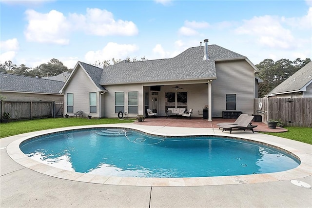 view of swimming pool featuring ceiling fan, a yard, a patio, and an outdoor living space