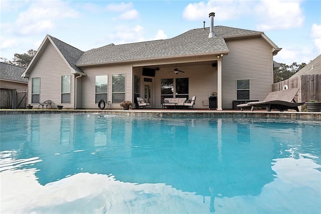 view of pool with an outdoor living space and ceiling fan