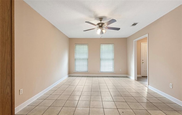 empty room featuring ceiling fan and light tile patterned floors