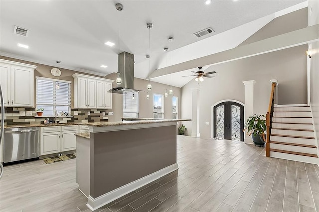 kitchen featuring french doors, visible vents, island range hood, and stainless steel dishwasher