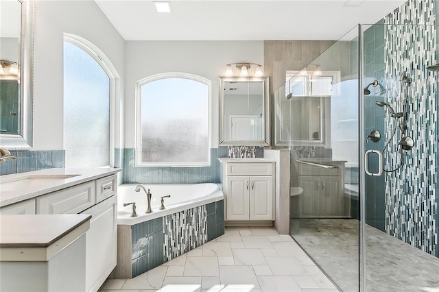 bathroom featuring a healthy amount of sunlight, a shower stall, a sink, and a bath