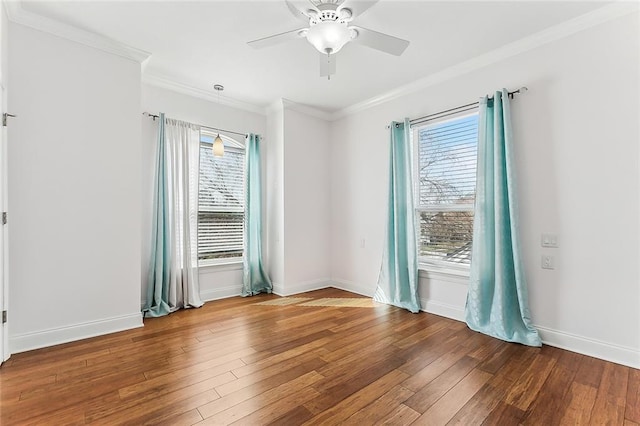 unfurnished room featuring ceiling fan, ornamental molding, wood finished floors, and baseboards