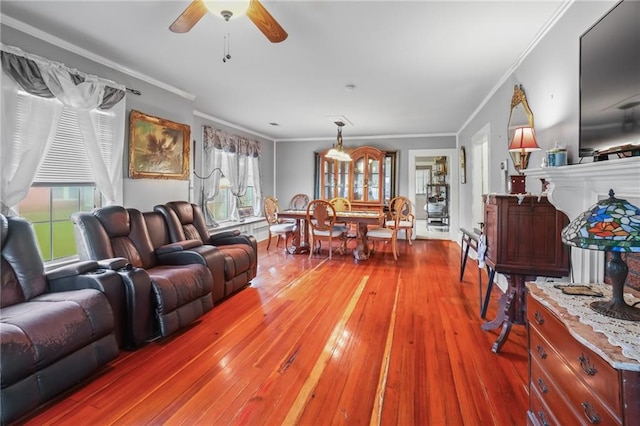 living room featuring hardwood / wood-style flooring, ceiling fan, and crown molding