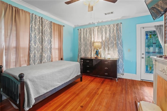 bedroom featuring access to outside, hardwood / wood-style flooring, ceiling fan, and crown molding