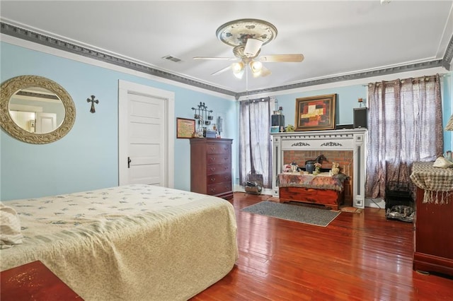 bedroom with hardwood / wood-style flooring, ceiling fan, and crown molding