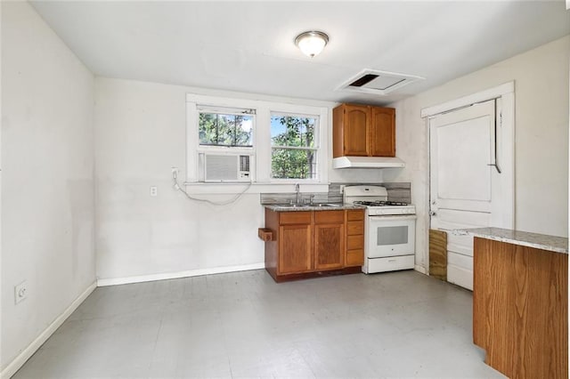 kitchen with light stone counters, cooling unit, white gas stove, and sink