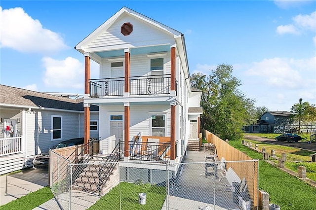 view of front of property with a porch and a balcony