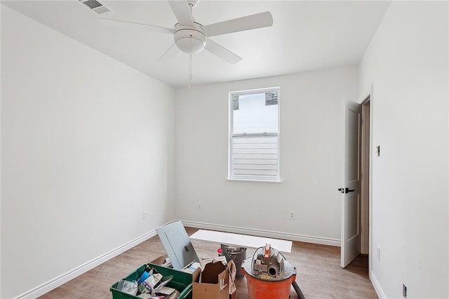 empty room with hardwood / wood-style floors and ceiling fan