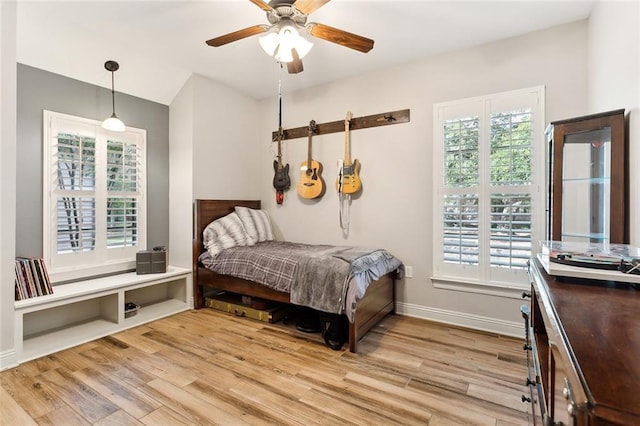 sitting room featuring a barn door, wood-type flooring, and crown molding