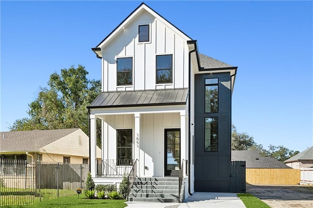 modern inspired farmhouse featuring a porch and a front yard