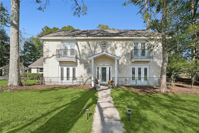 view of front of property with french doors and a front yard