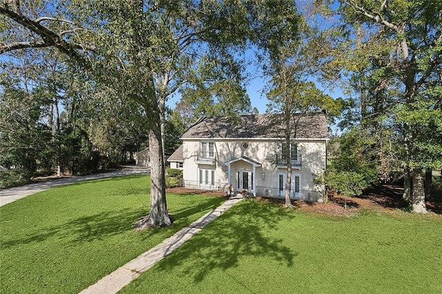 view of front of property with a front yard and french doors