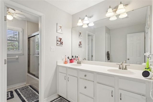 bathroom featuring vanity, shower / bath combination with glass door, and ceiling fan