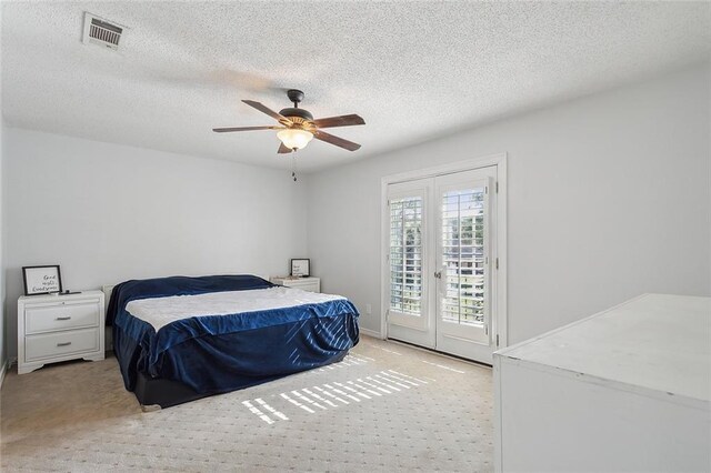 bedroom featuring a textured ceiling, ceiling fan, and access to outside