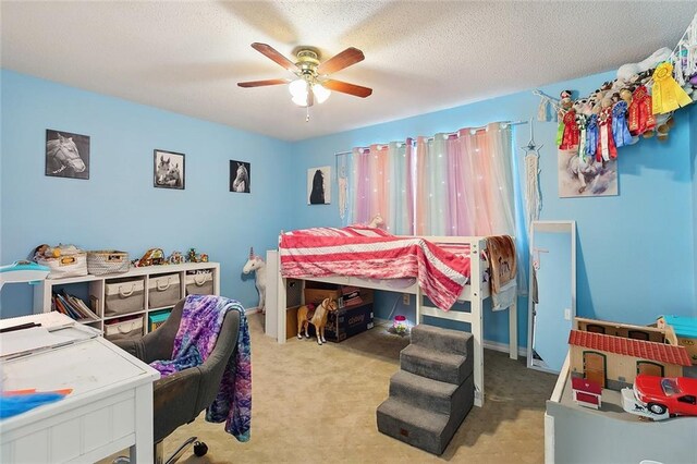 bedroom featuring ceiling fan, light carpet, and a textured ceiling