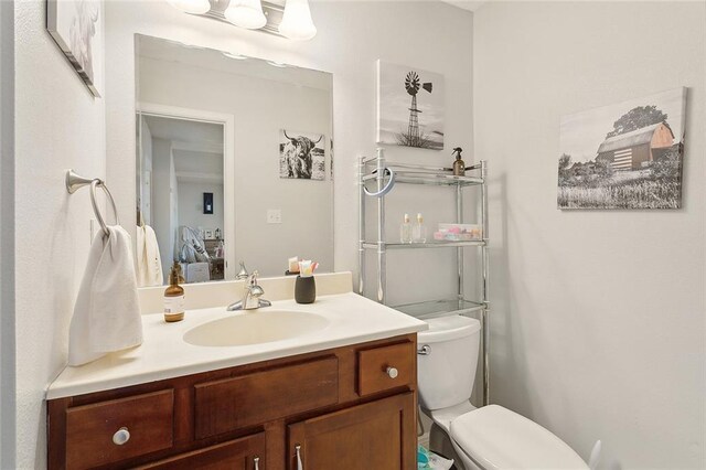 bathroom featuring toilet and vanity