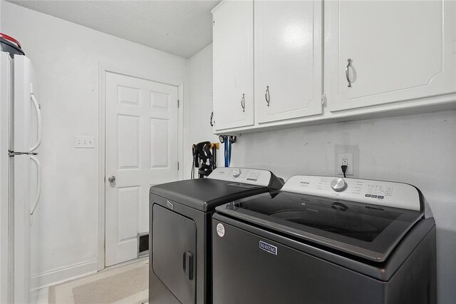 laundry area featuring cabinets and separate washer and dryer