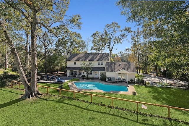 view of pool featuring a patio and a lawn