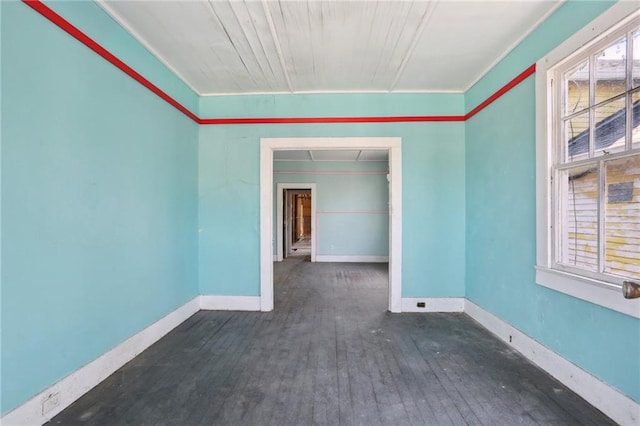 empty room featuring crown molding and dark wood-type flooring