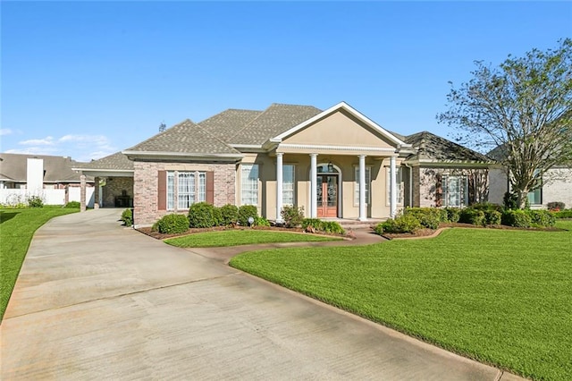 view of front of home with a front yard and a carport