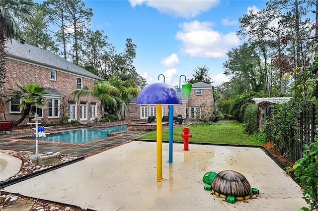 view of pool featuring a yard and a patio area