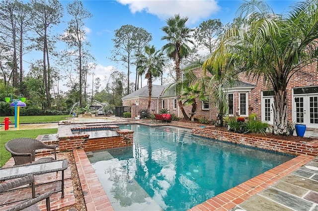 view of swimming pool with a lawn