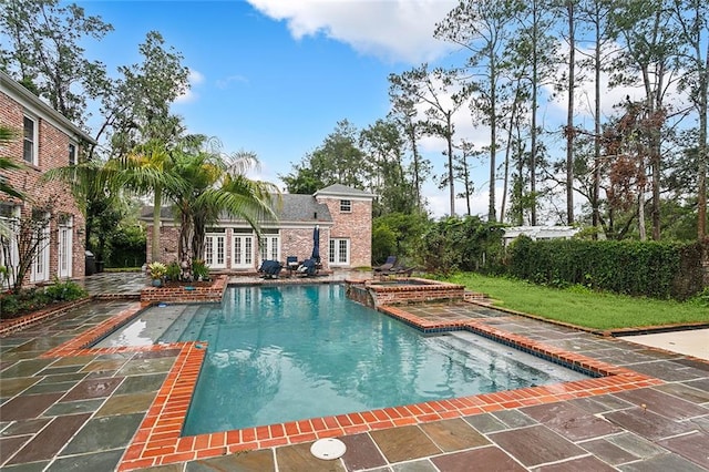 view of swimming pool featuring a patio area and french doors