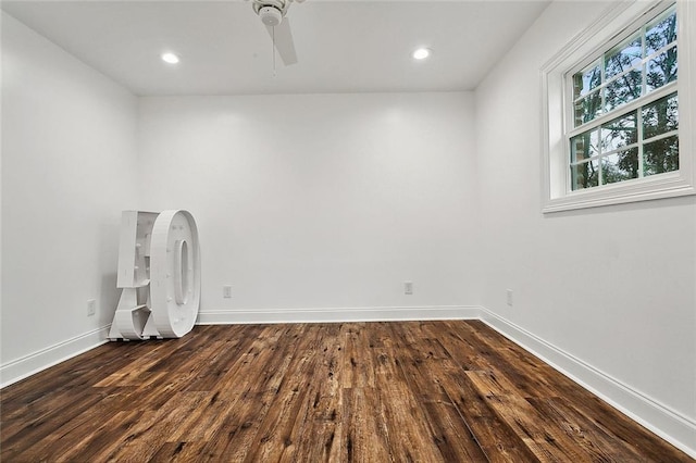 empty room with ceiling fan and dark hardwood / wood-style floors