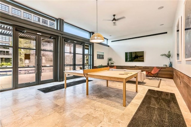 recreation room featuring ceiling fan and french doors