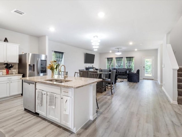 24440 Dawson Ct, Ponchatoula, LA 70454 - kitchen featuring a sink, stainless steel appliances, light wood-type flooring, white cabinetry, and recessed lighting
