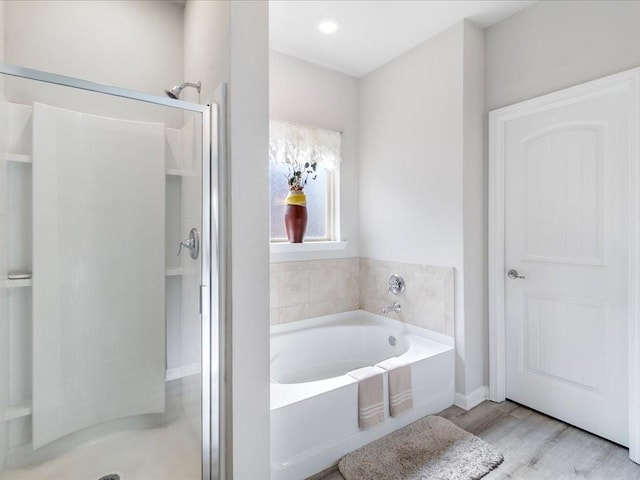 24440 Dawson Ct, Ponchatoula, LA 70454 - bathroom with a stall shower, a garden tub, and wood finished floors