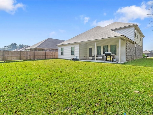 back of property featuring a yard and a patio area