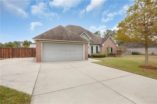 view of front of house featuring a garage and a front lawn