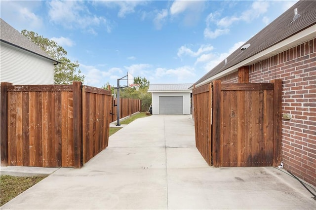 view of patio / terrace featuring an outdoor structure and a garage