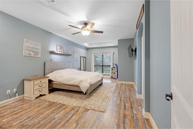 bedroom featuring hardwood / wood-style flooring and ceiling fan