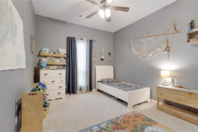 carpeted bedroom with ceiling fan and vaulted ceiling