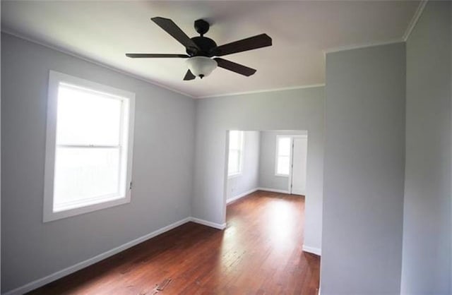 spare room featuring ceiling fan, dark hardwood / wood-style flooring, and ornamental molding