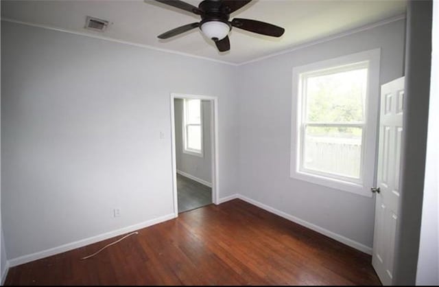 spare room featuring ceiling fan, ornamental molding, and dark wood-type flooring