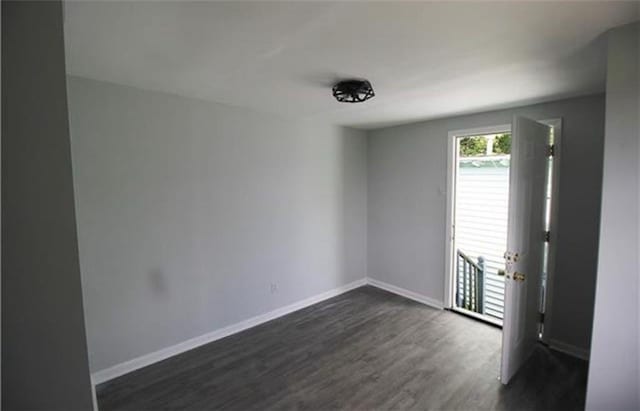 spare room featuring dark hardwood / wood-style flooring