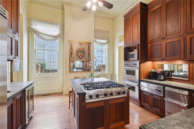 kitchen with light hardwood / wood-style flooring, wine cooler, crown molding, stainless steel appliances, and ceiling fan